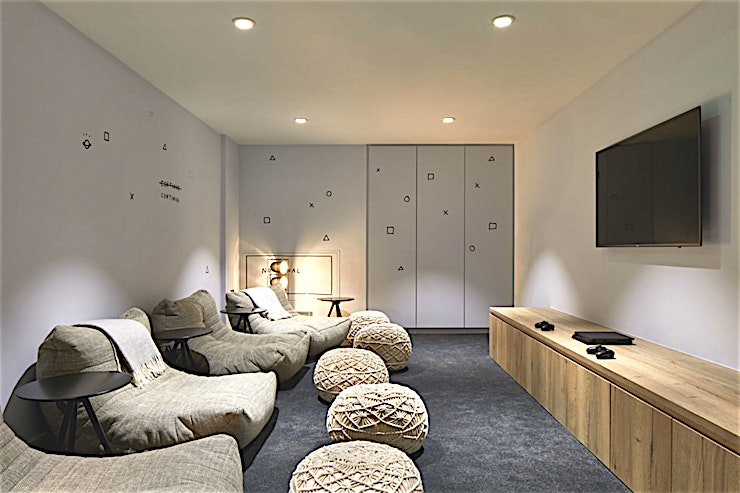 Small Screening Room **The Small Screen room - with playful game-themed wall art - can be set up with comfy chairs as an informal space or as a more formal meeting room with a table.**
It’s perfect for smaller groups a